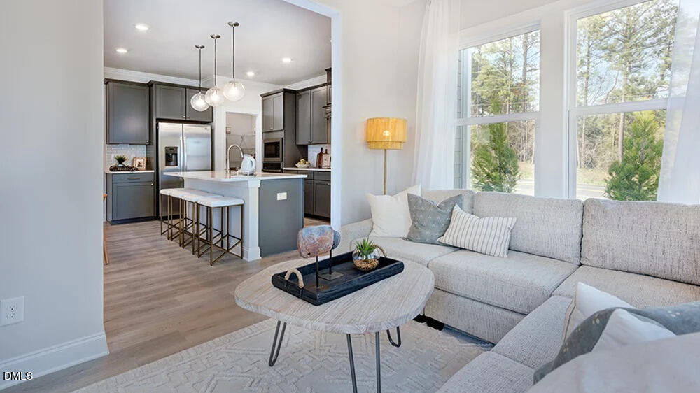229 Tidal Pool Way Cary, NC 27519 - Photo 15 of 32 a living room with furniture kitchen area and a large window