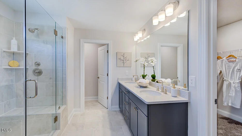 229 Tidal Pool Way Cary, NC 27519 - Photo 21 of 32 a bathroom with a sink vanity granite shower and a mirror