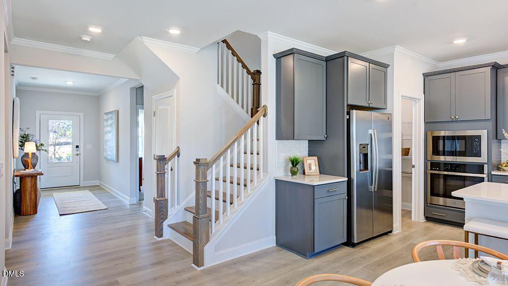 229 Tidal Pool Way Cary, NC 27519 - Photo 6 of 32 a kitchen with stainless steel appliances kitchen island granite countertop a refrigerator and a sink