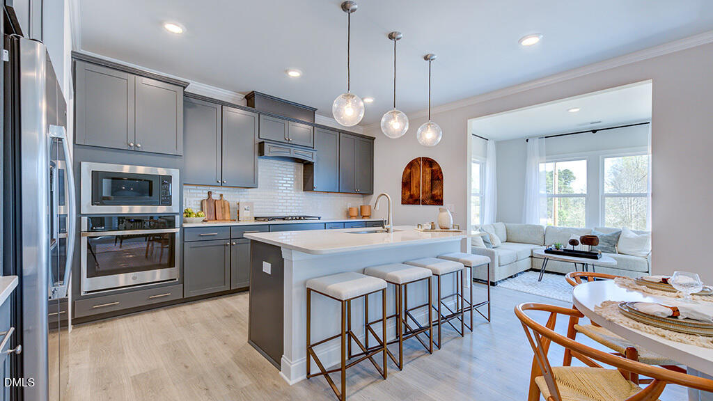 229 Tidal Pool Way Cary, NC 27519 - Photo 7 of 32 a large kitchen with a table and chairs in it