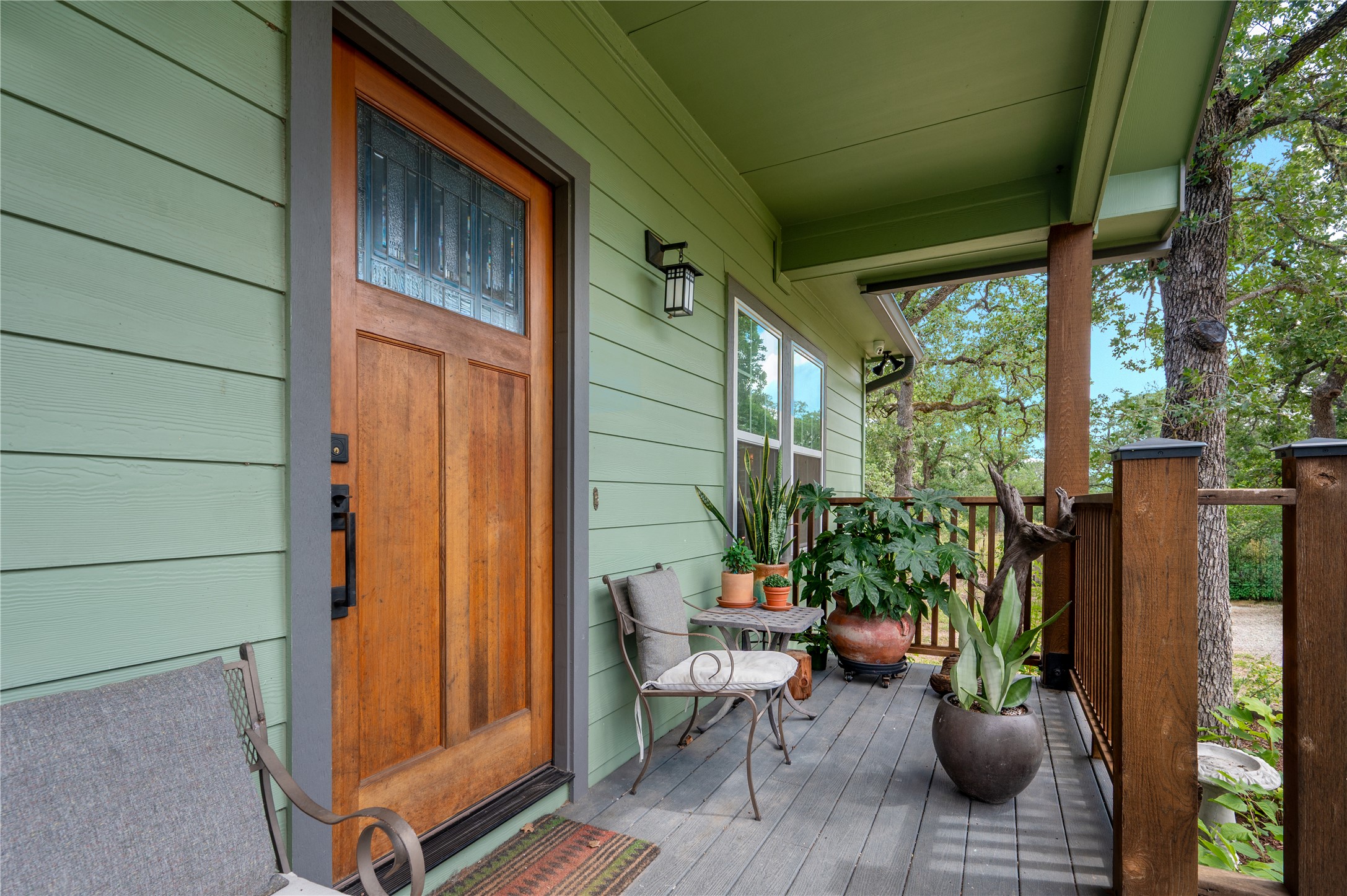 270 Dry Creek Road Manor, TX 78653 - Photo 20 of 40 A welcoming front porch features wood siding and a decorative glass door, offering a cozy outdoor retreat.
