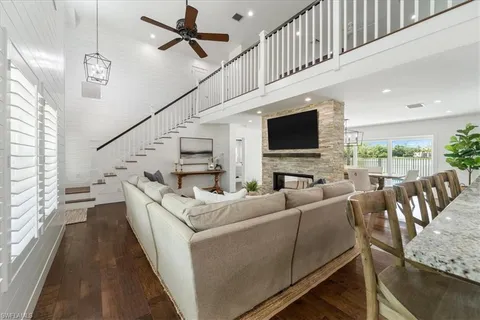 a living room with furniture flat screen tv and a fireplace