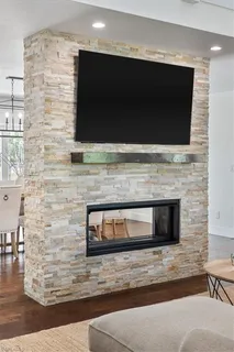 a living room with a fireplace and a flat screen tv