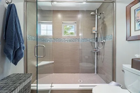 a bathroom with a granite countertop bathtub shower sink and toilet
