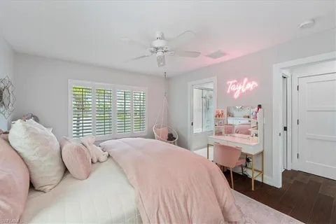 a bedroom with a bed mirror and a window