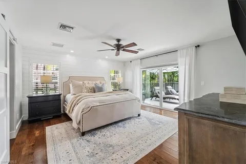 a spacious bedroom with a bed and a table in it