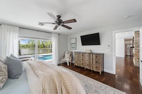 a bedroom with furniture and a flat screen tv