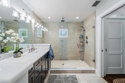 a bathroom with a sink a toilet and shower