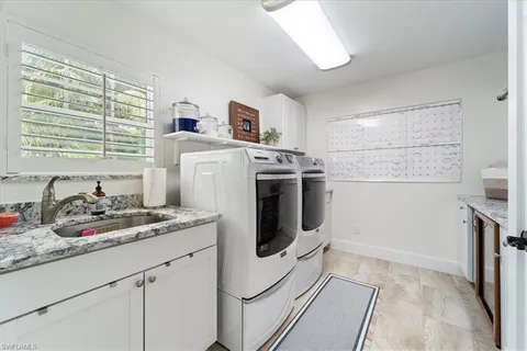 a utility room with sink dryer and washer