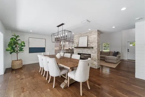 a view of a dining room with furniture wooden floor and chandelier