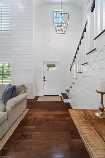 a view of entryway and hall with wooden floor