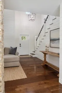 a living room with hardwood floor and a ceiling fan