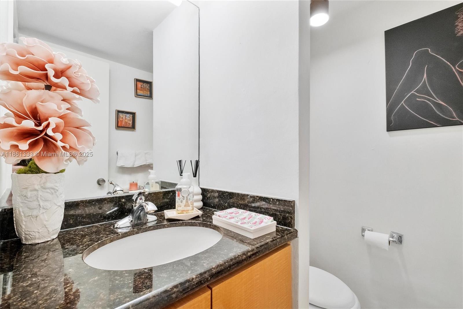 10409 Southwest 80th Street Miami, FL 33173 - Photo 11 of 35 a bathroom with a granite countertop sink and a mirror