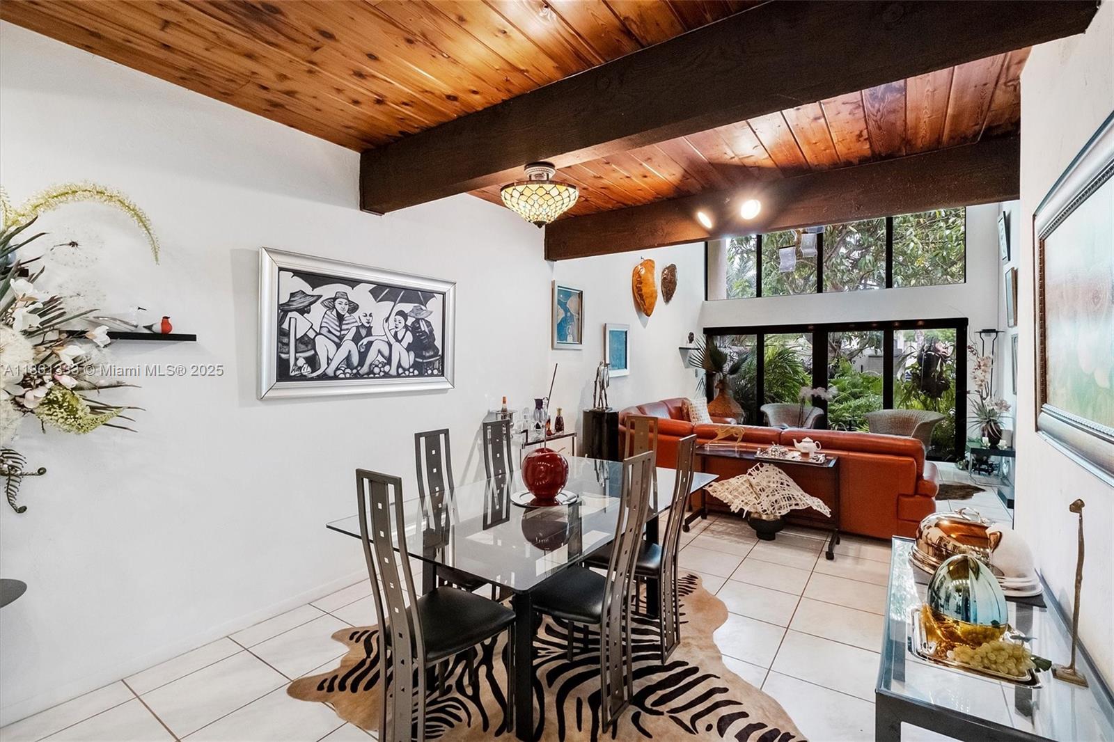 10409 Southwest 80th Street Miami, FL 33173 - Photo 20 of 35 a dining room with furniture a rug and a large window