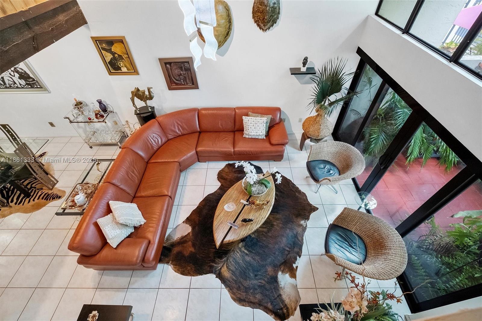 10409 Southwest 80th Street Miami, FL 33173 - Photo 22 of 35 a living room with furniture and a floor to ceiling window