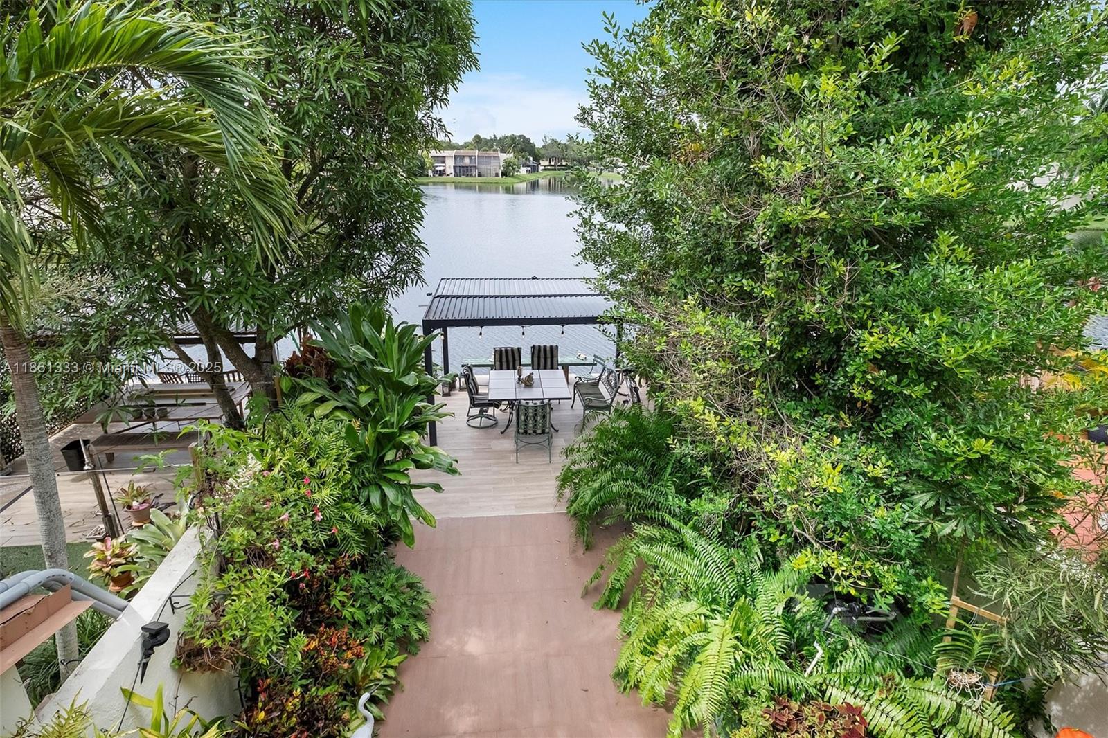 10409 Southwest 80th Street Miami, FL 33173 - Photo 26 of 35 a view of a patio with table and chairs and potted plants