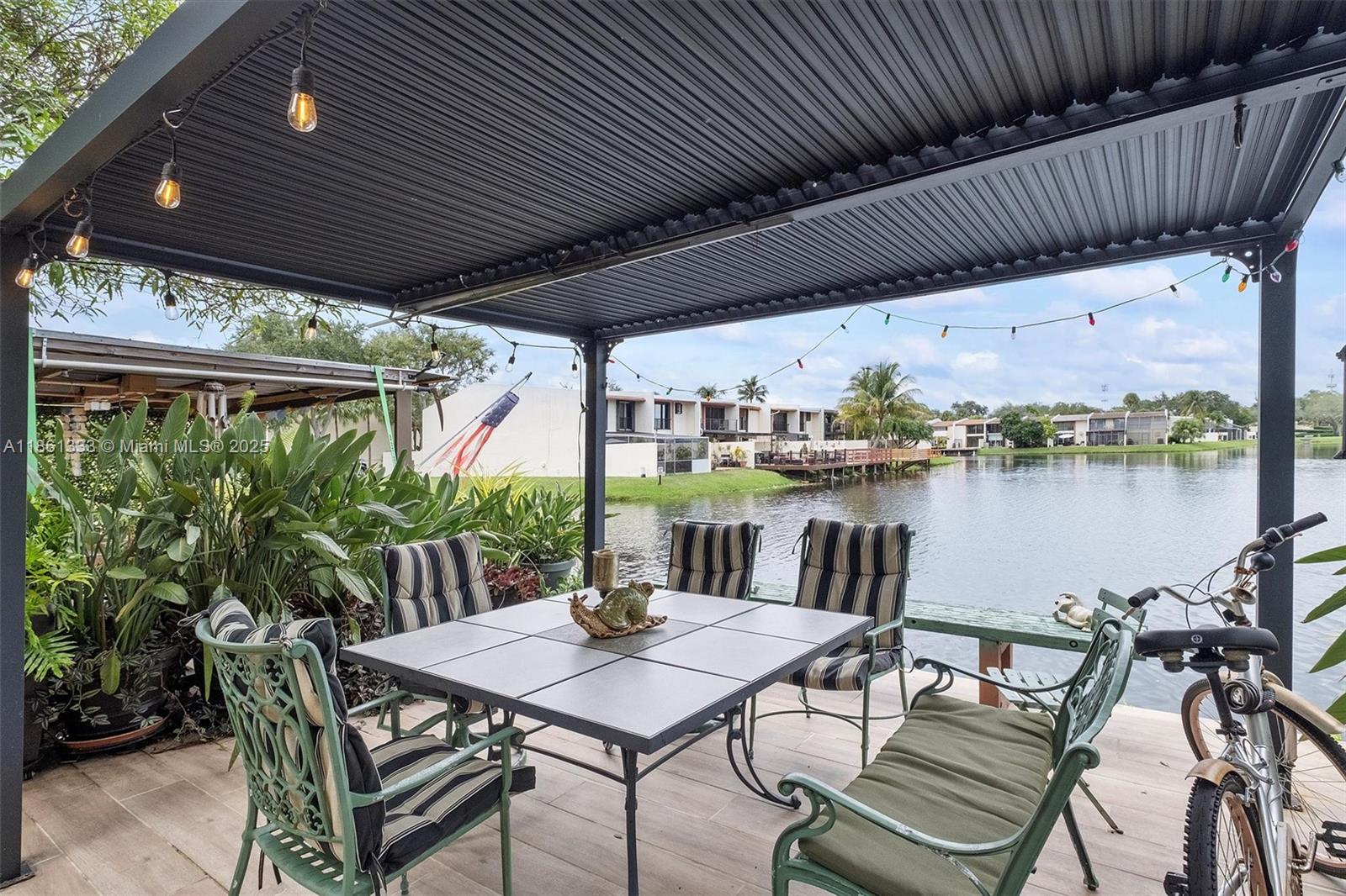 10409 Southwest 80th Street Miami, FL 33173 - Photo 31 of 35 a patio with water view fountain with plants and lake view