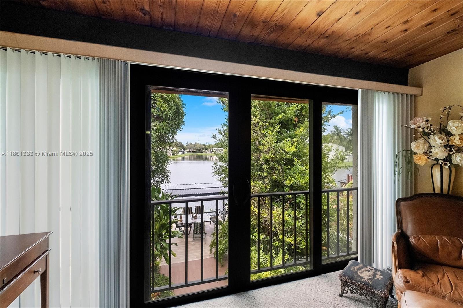10409 Southwest 80th Street Miami, FL 33173 - Photo 5 of 35 a view of a balcony with furniture and floor to ceiling window