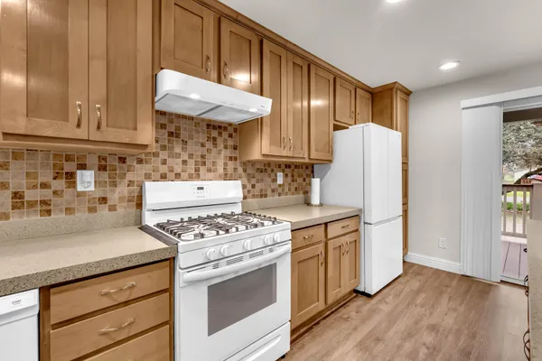 a kitchen with stainless steel appliances a sink and a refrigerator