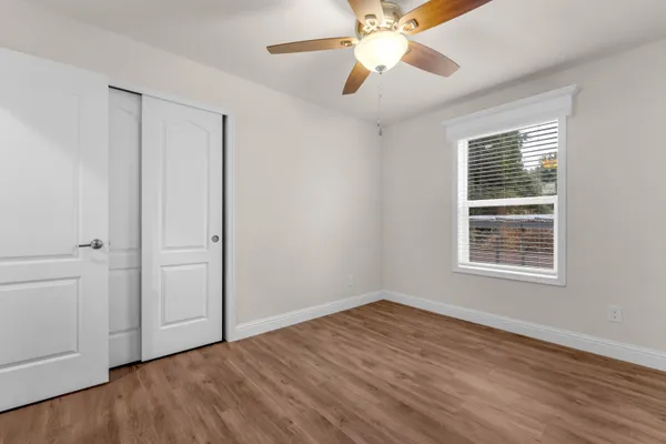 wooden floor in an empty room with a window