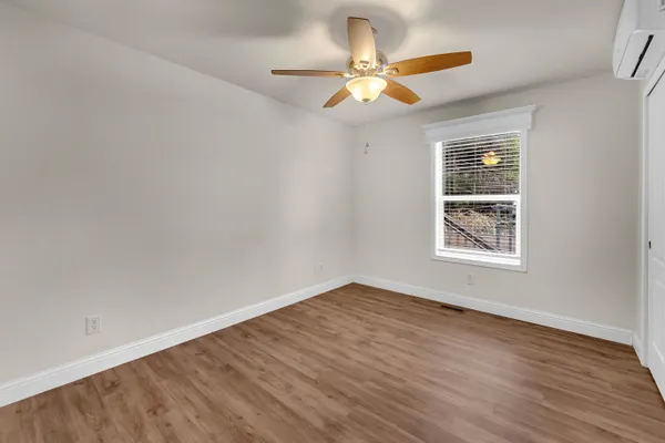 a view of a house with a big yard and large trees