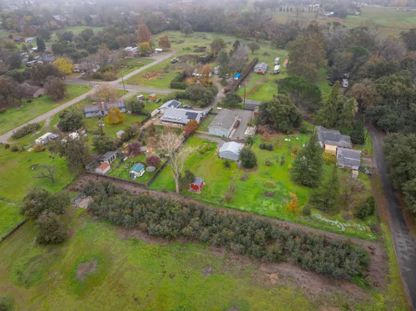 an aerial view of a residential houses with outdoor space