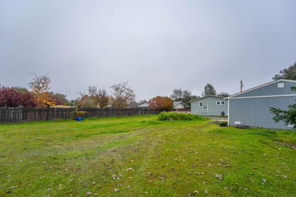 a patio with a table and chairs and a fire pit