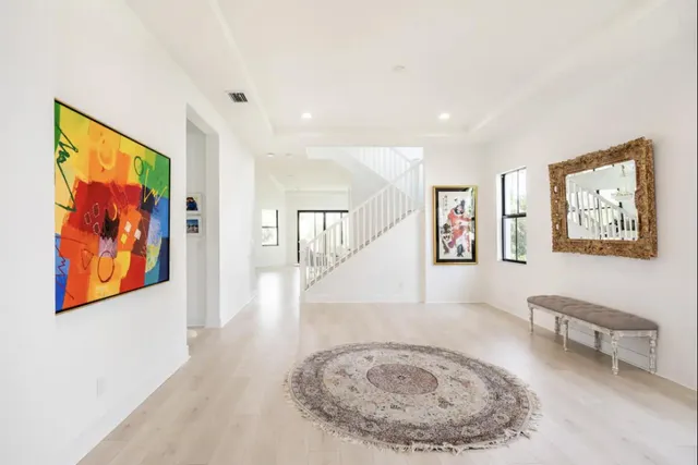 a view of a hallway with painting on the wall