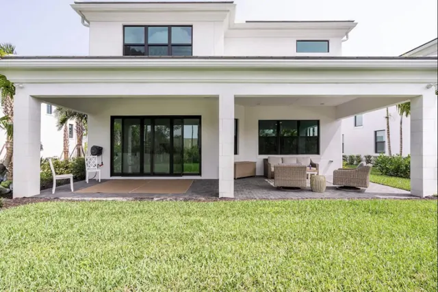 a view of a house with a patio and a garden