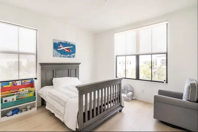 a bedroom with furniture and a window