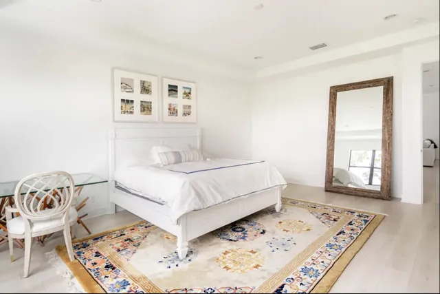 a bedroom with a bed a table and chair