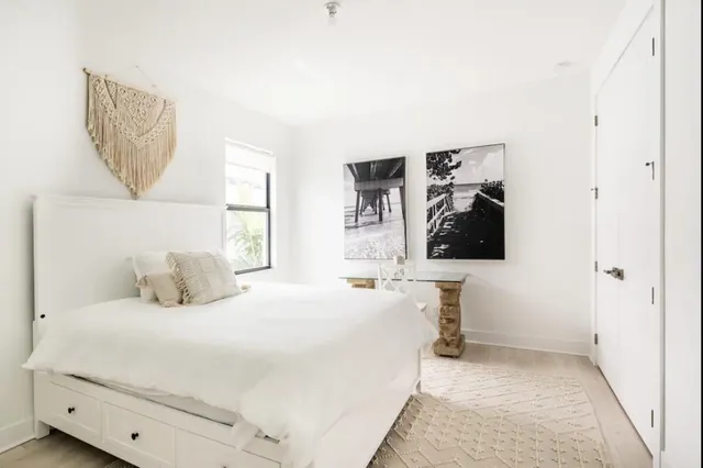 a bedroom with a bed and a painting on the wall