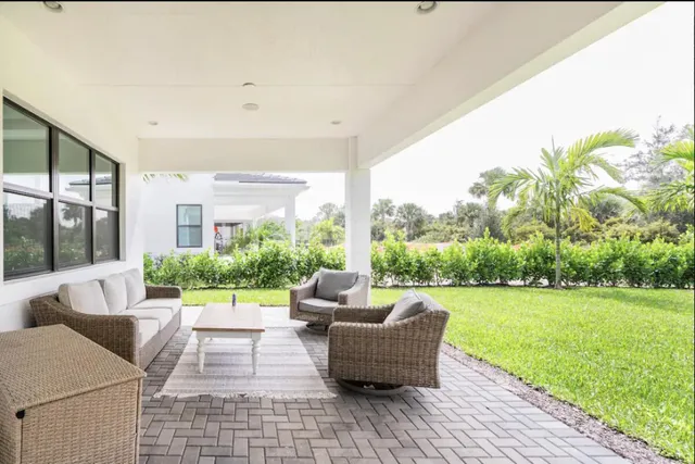 a patio with patio couch and a garden