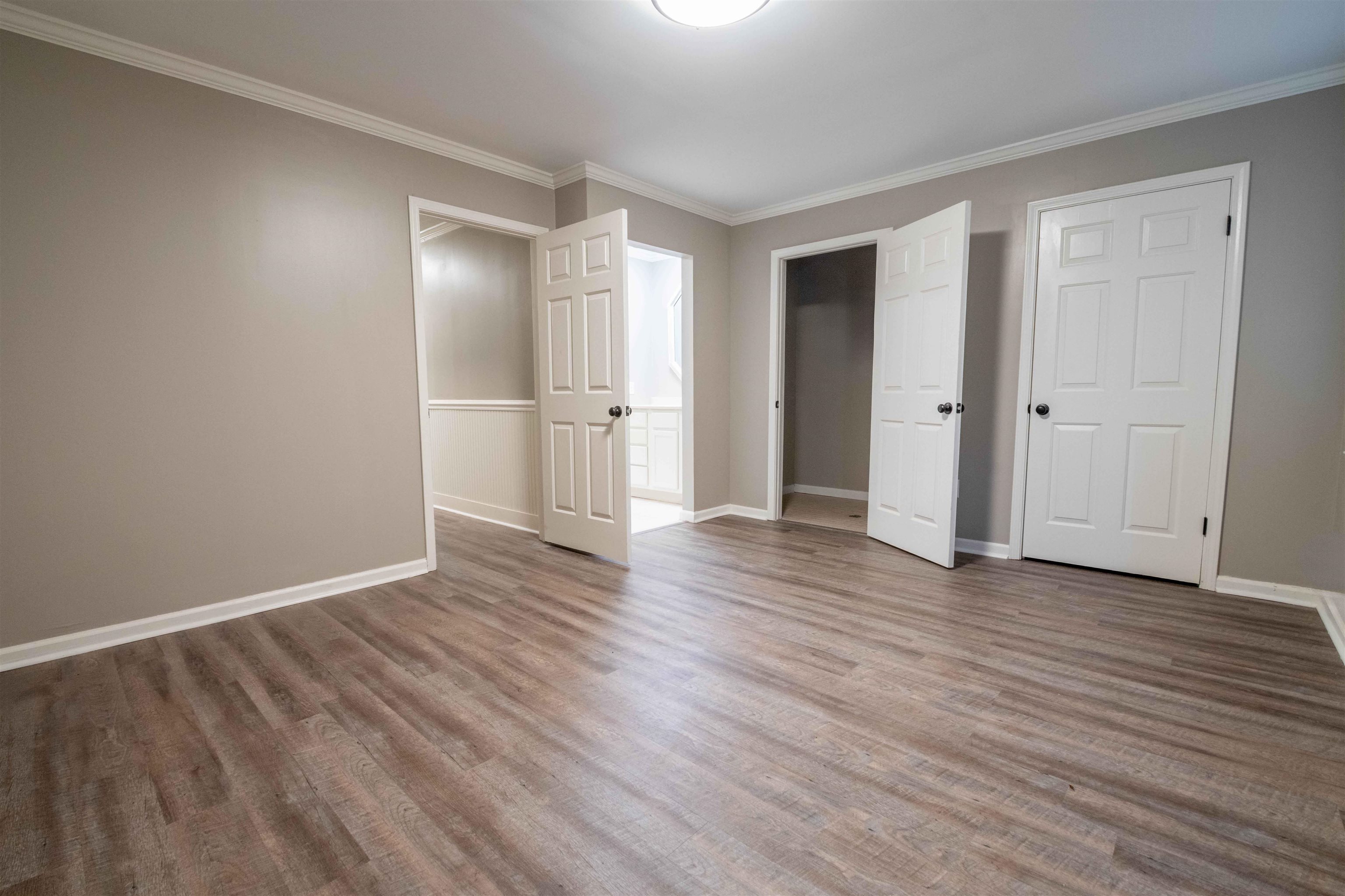 1239 Whitten Road Memphis, TN 38134 - Photo 12 of 24 Unfurnished bedroom with crown molding, wood finished floors, a closet, and ensuite bath