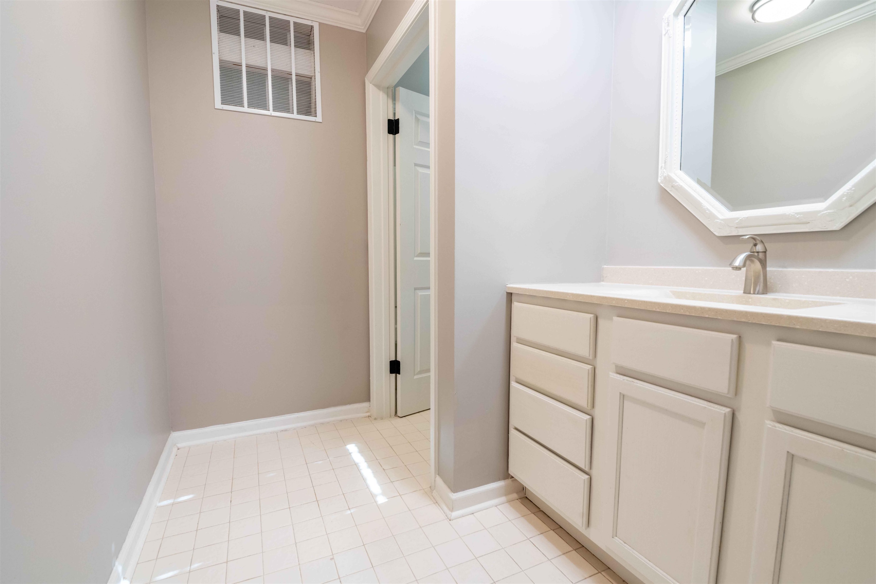 1239 Whitten Road Memphis, TN 38134 - Photo 13 of 24 Bathroom featuring crown molding, vanity, and light tile patterned flooring