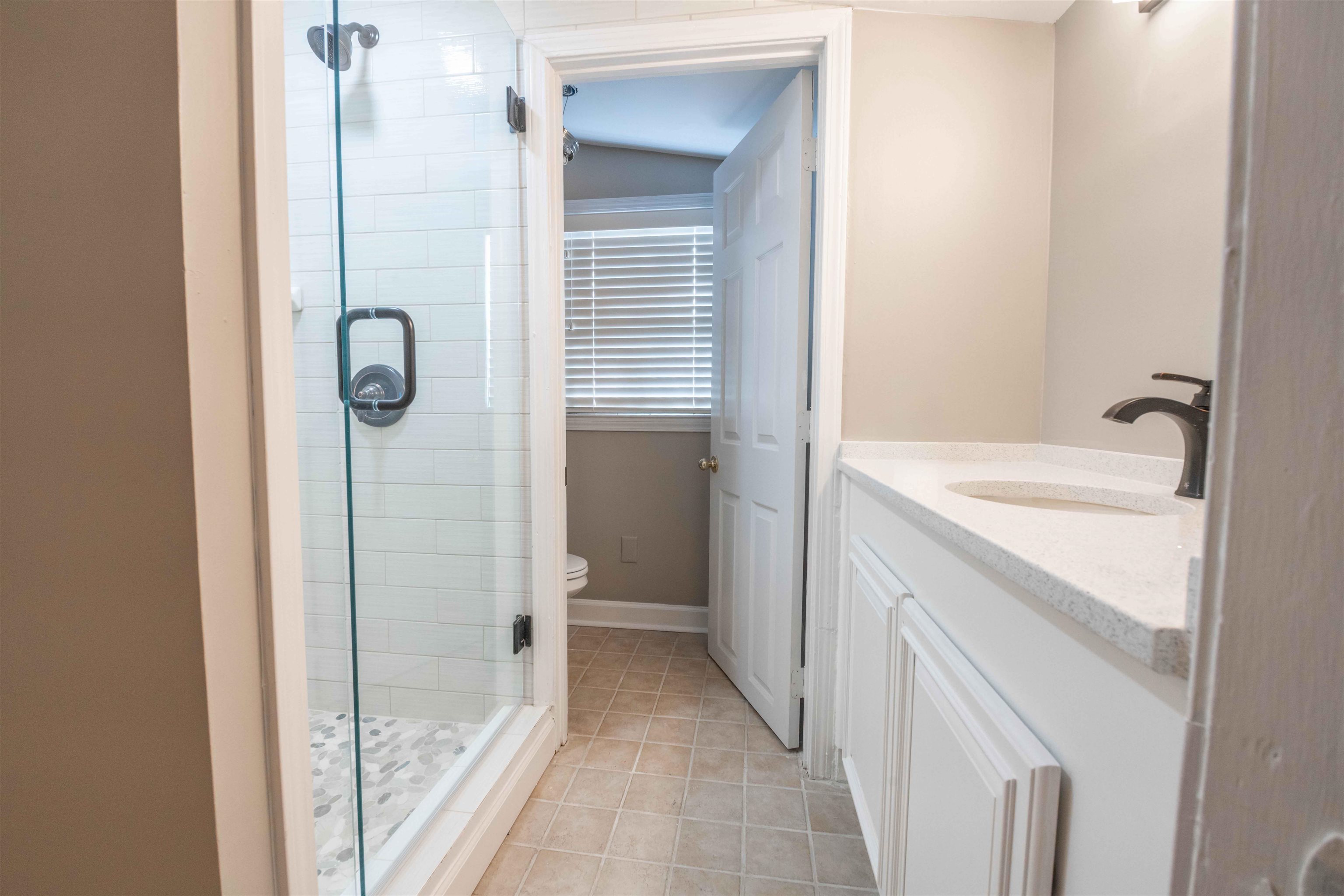 1239 Whitten Road Memphis, TN 38134 - Photo 15 of 24 Full bath with vanity, a stall shower, and light tile patterned flooring