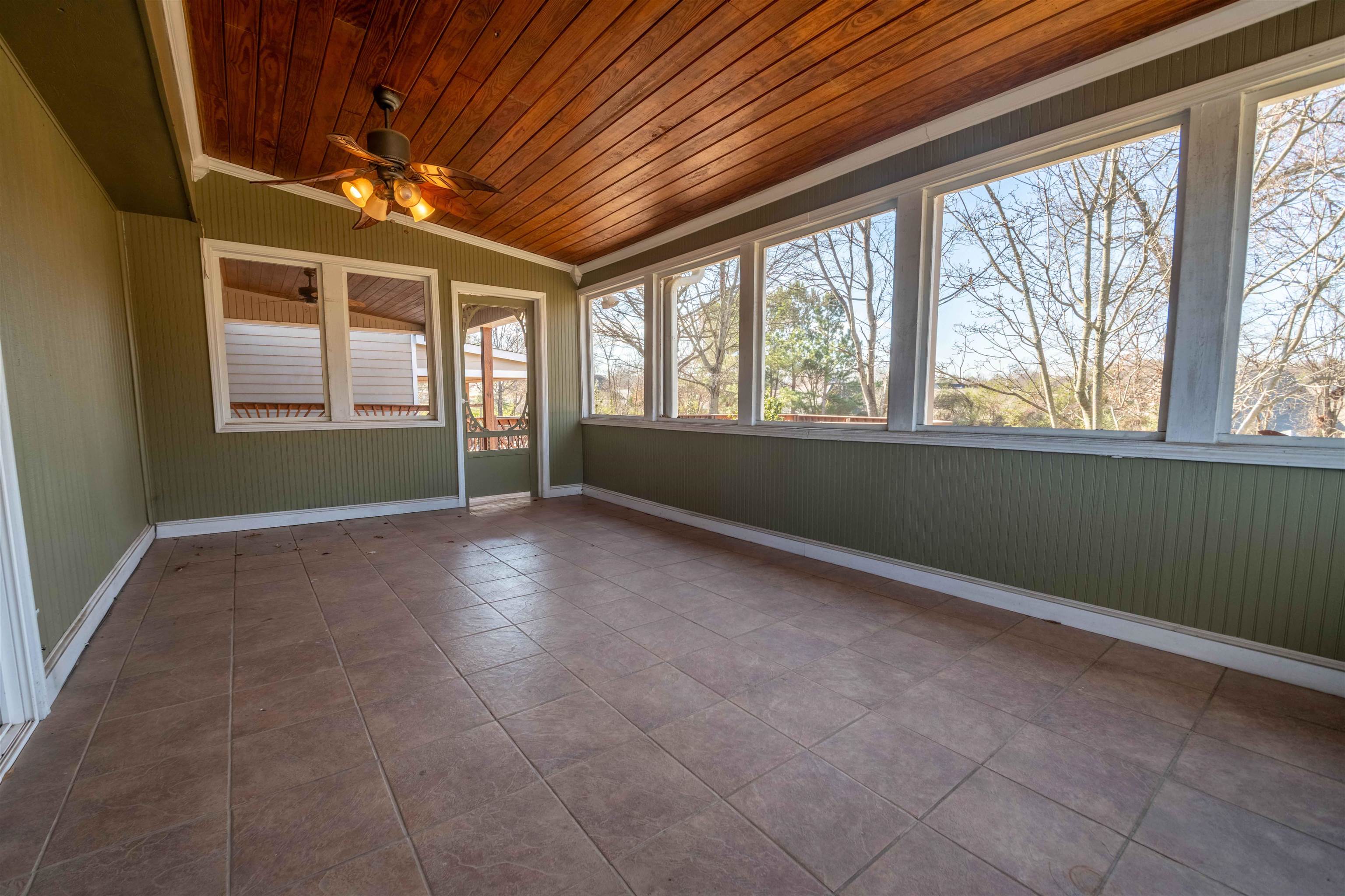 1239 Whitten Road Memphis, TN 38134 - Photo 5 of 24 Unfurnished sunroom with wooden ceiling, ornamental molding, and wooden walls