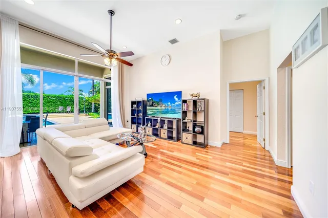 a living room with patio furniture and a flat screen tv