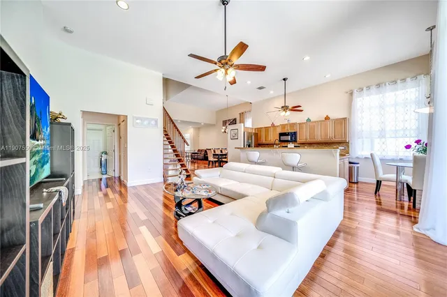 a living room with stainless steel appliances kitchen island granite countertop furniture and a kitchen view