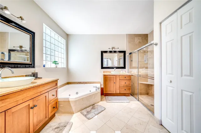 a spacious bathroom with a tub sink and mirror