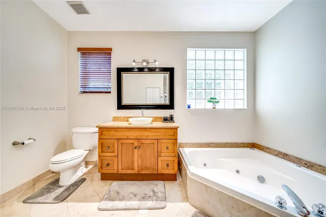 a bathroom with a bathtub sink and toilet