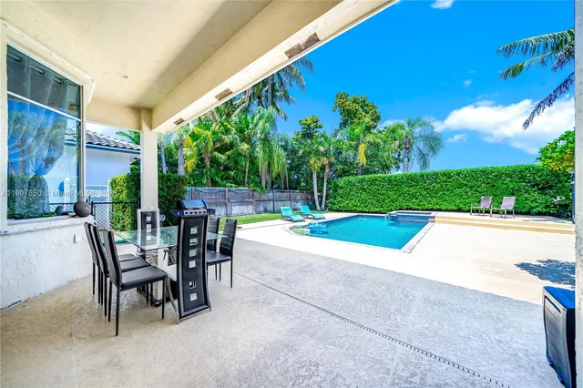 a view of a patio with a table and chairs