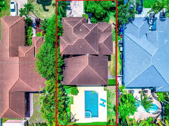 an aerial view of house with yard and outdoor seating