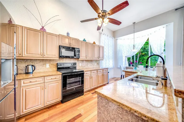 a kitchen with a stove a sink and a microwave