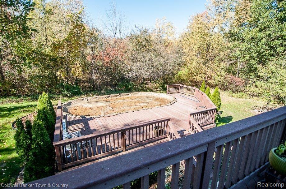 4885 Crooked Lake Road Howell, MI 48843 - Photo 13 of 35 Large deck surrounding pool