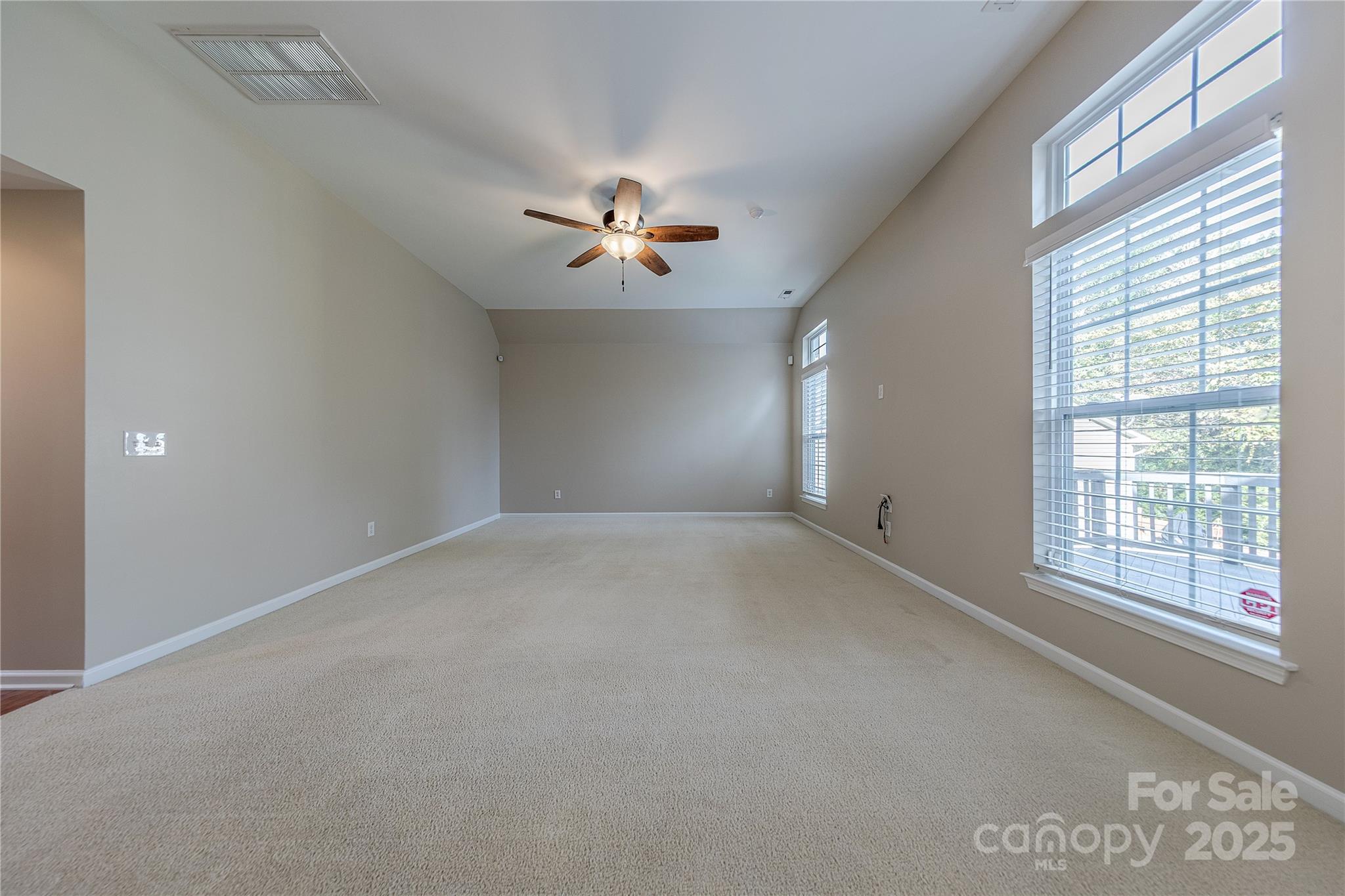 7216 Meyer Road Fort Mill, SC 29715 - Photo 11 of 47 en empty room with windows and ceiling fan