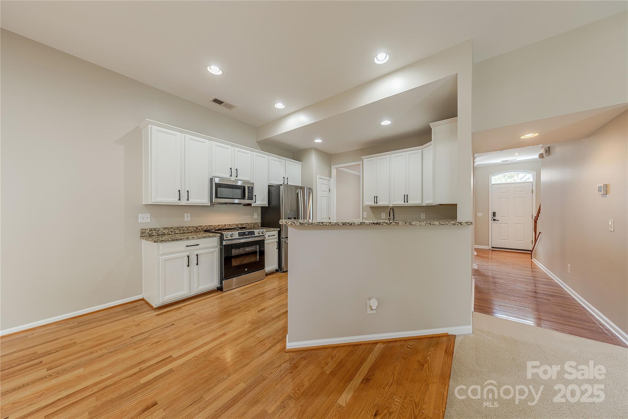 7216 Meyer Road Fort Mill, SC 29715 - Photo 12 of 47 a large kitchen with stainless steel appliances granite countertop a stove a sink and a refrigerator