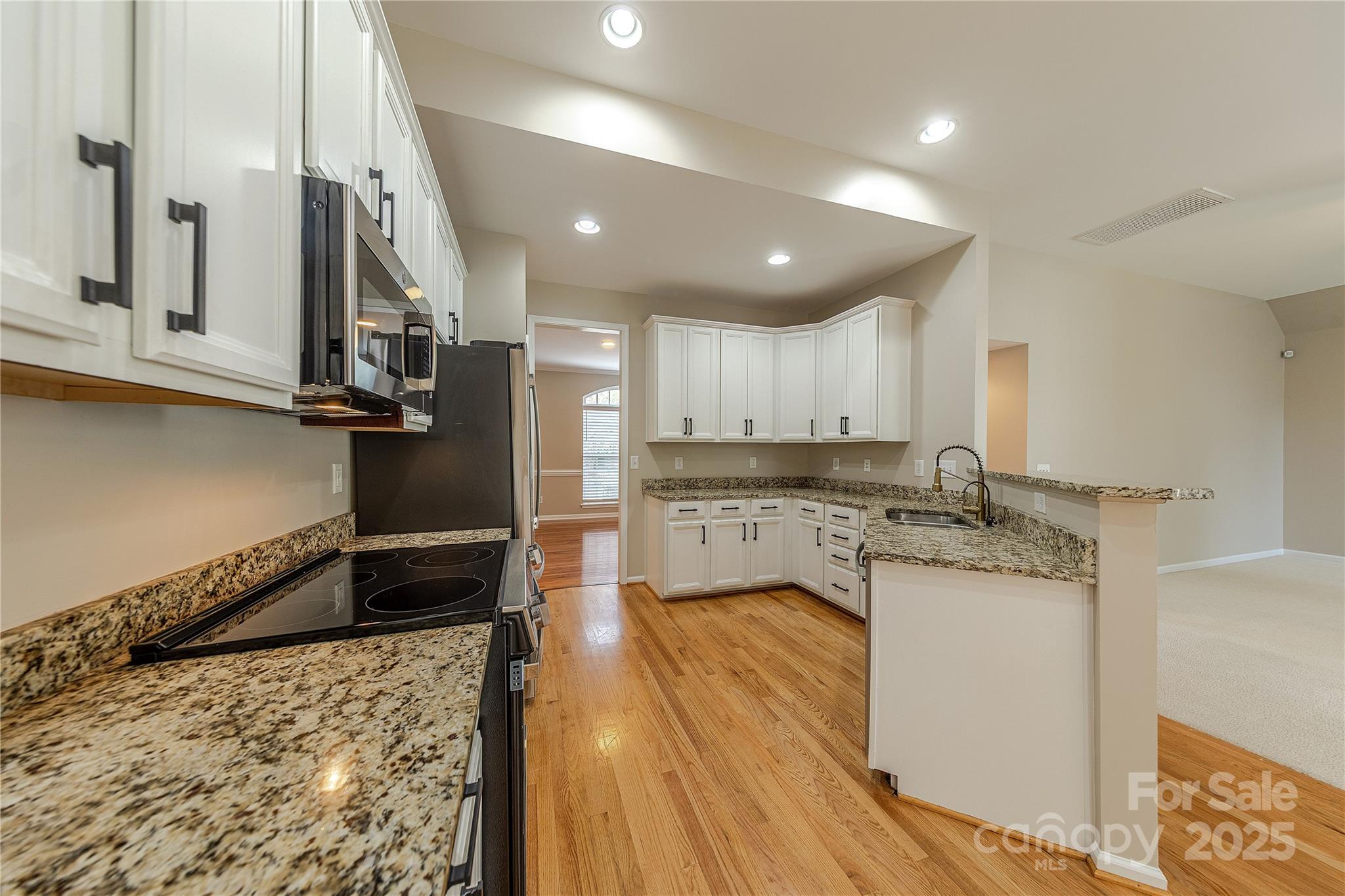 7216 Meyer Road Fort Mill, SC 29715 - Photo 14 of 47 a kitchen with stainless steel appliances granite countertop a sink refrigerator and cabinets