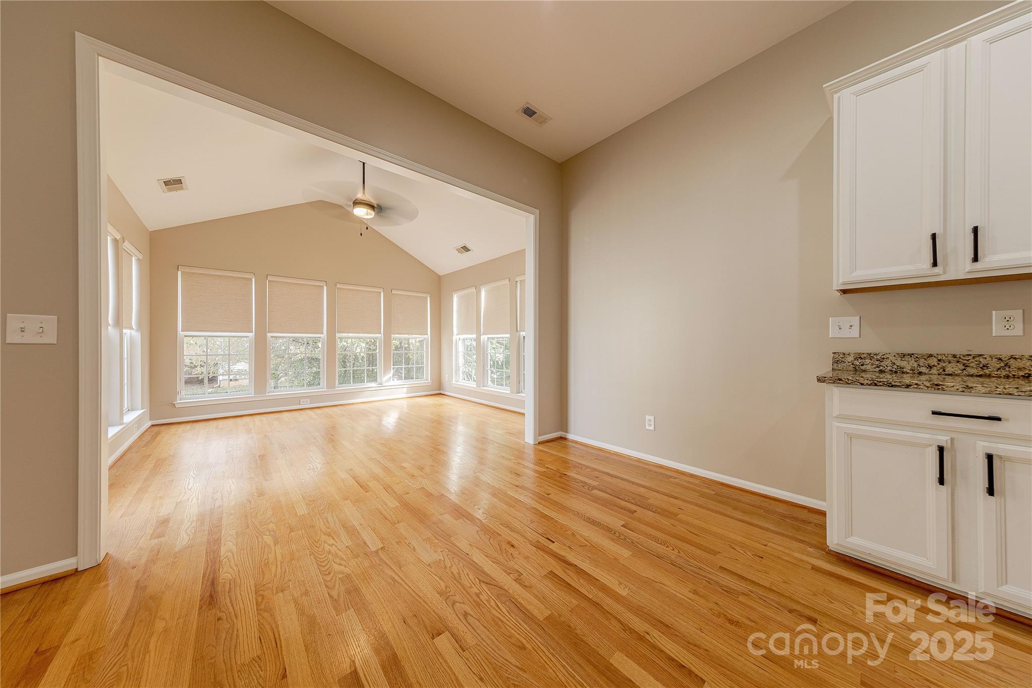 7216 Meyer Road Fort Mill, SC 29715 - Photo 20 of 47 a view of an empty room with wooden floor and a window