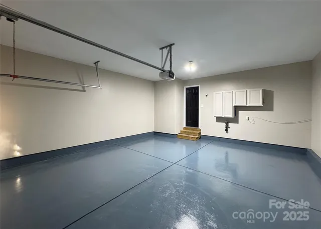 a view of a kitchen with a dishwasher and white cabinets